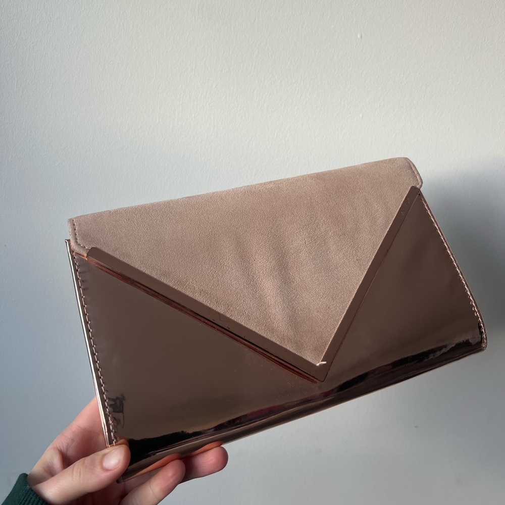 Also suede copper clutch bag with metal strap